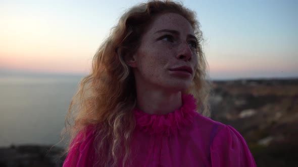 Close Up Shot of Beautiful Young Caucasian Woman with Curly Blond Hair and Freckles Looking at