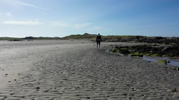 Pretty Lady Walking on Lonely Sandy Beach