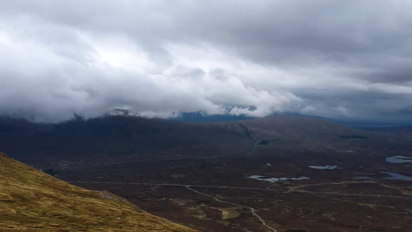 Cinematic drone timelapse of cloudy scottish highland mountains