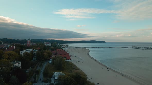 Seaside resort city and sandy beach at the coast of Baltic Sea. Aerial trucking