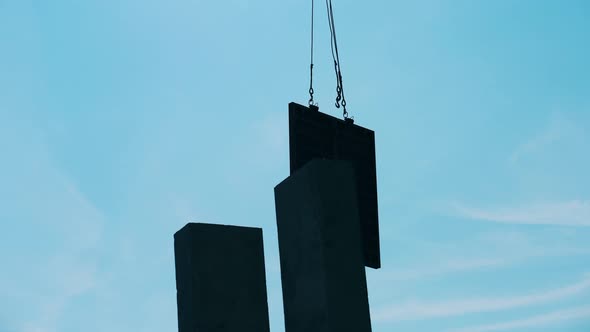 A Crane Moves Metal Blocks on a Construction Site.