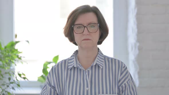 Portrait of Sad Senior Woman Looking at Camera