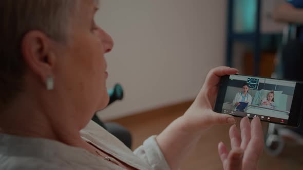 Retired Person Using Remote Teleconference to Talk to Doctor and Niece