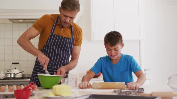 Caucasian father and son baking together in the kitchen at home