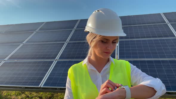 Portrait of Beautiful Female Engineer Technologist Standing Among Solar Panels