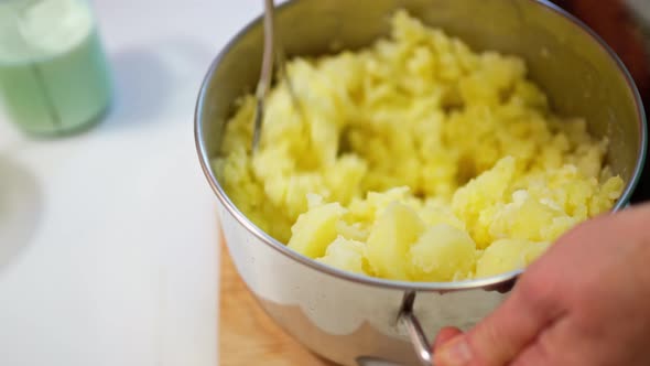 Female Hands Prepare Mashed Potatoes Mix Mashed Boiled Potatoes with a Crush