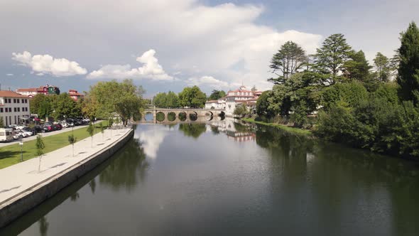 Aerial slowly rotating over Tamega river panorama at Chaves Downtown - Portugal