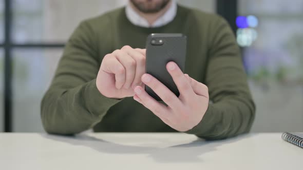 Close Up of Young Businessman Using Smartphone