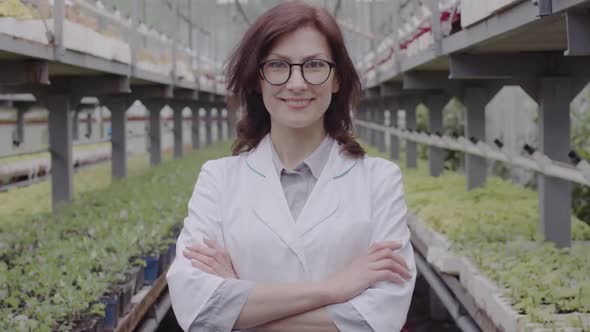 Confident Smiling Professional Biologist Crossing Hands and Smiling at Camera. Middle Shot Portrait