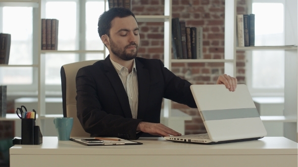 Businessman Finished Work In Front Of a Laptop