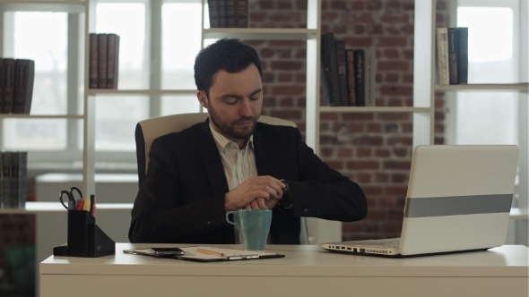 Businessman With a Laptop And Tea Looking