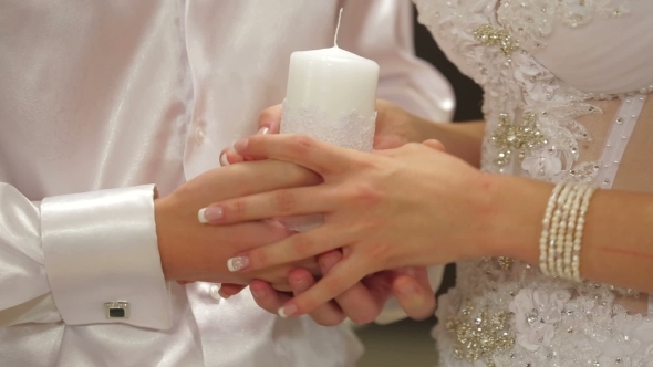 Married Couple Holding Unity Candle 