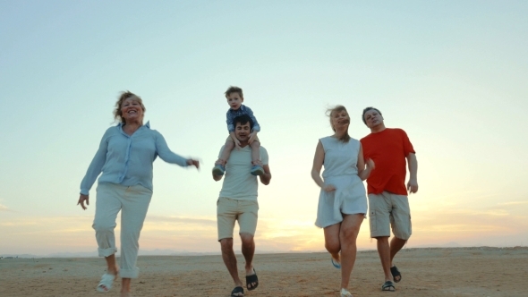 Enjoable Family Walk On The Beach