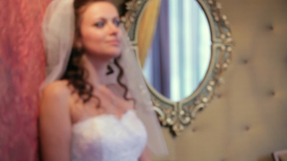 Bride Posing In A Room With A Mirror