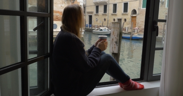 Woman With Tea Enjoying Scene From The Window