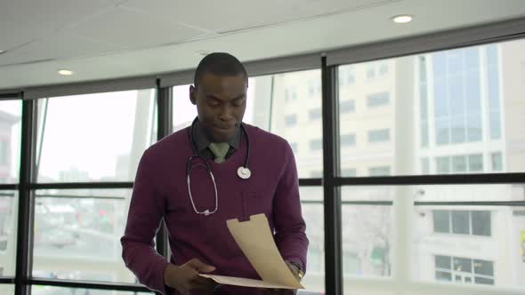 A Black Male Medical Professional Walks Up To The Camera (4 Of 5)