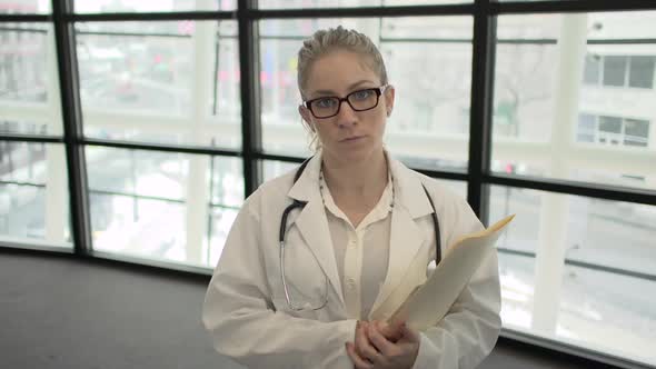 A Blonde Caucasian Female Medical Professional Walks Up To The Camera (1 Of 4)
