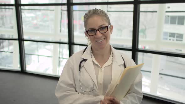 A Blonde Caucasian Female Medical Professional Walks Up To The Camera (2 Of 4)