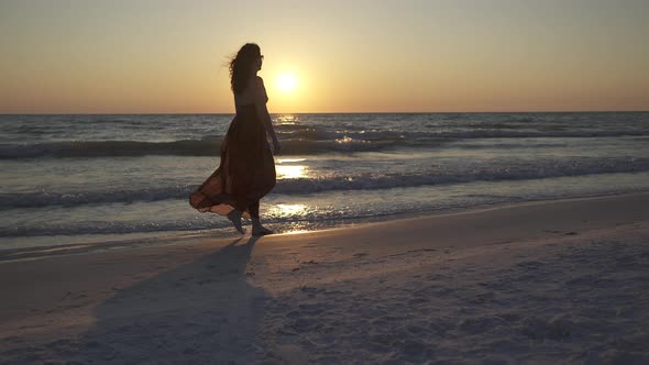 Woman Walking On Beach At Sunset (2 Of 2)