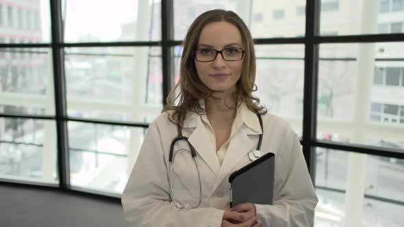 A Caucasian Female Medical Professional Walks Up To The Camera (2 Of 9)