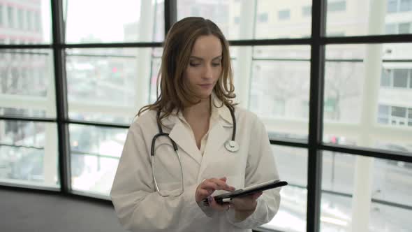 A Caucasian Female Medical Professional Walks Up To The Camera (6 Of 9) alt