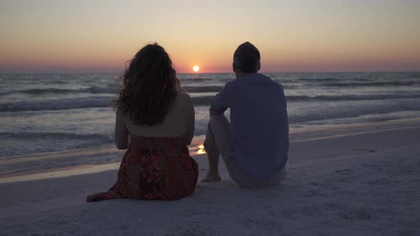 Couple Relaxing On Beach At Sunset (2 Of 5)