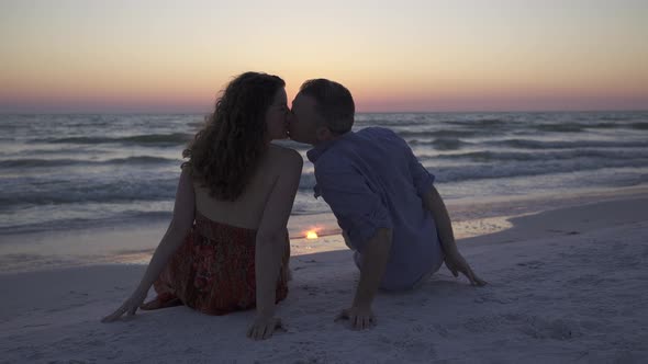 Couple Relaxing On Beach At Sunset (4 Of 5)