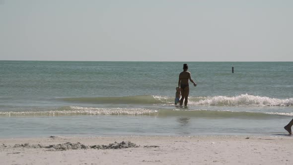 People Walk Along A Busy Beach (6 Of 9) alt