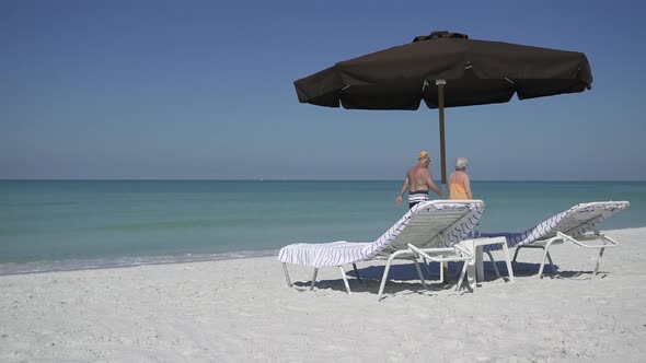 People Walk By An Umbrella At A Beach Resort (2 Of 3)
