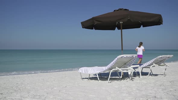 People Walk By An Umbrella At A Beach Resort (3 Of 3) alt