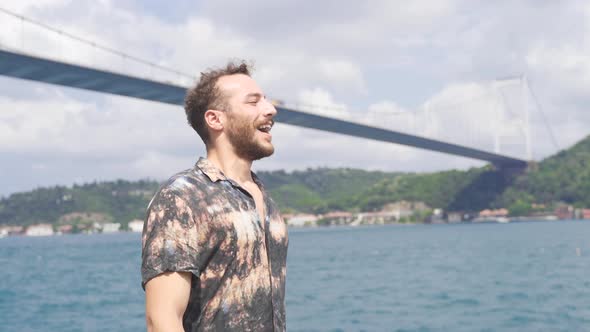 Happy young man walking happily by the sea.