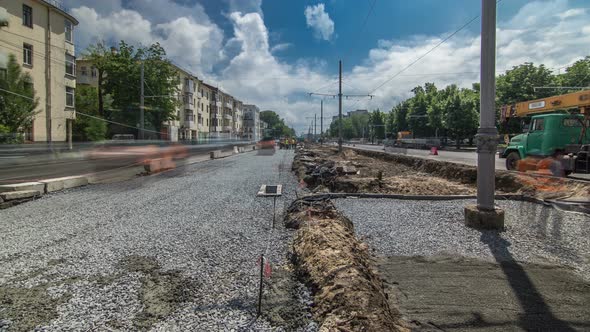 Orange Vibration Roller Compactor Rolls on a Stones at Road Construction and Repairing Timelapse