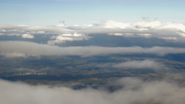 Aerial View To City Through The Clouds