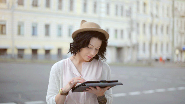 Girl Using Tablet PC on Street alt