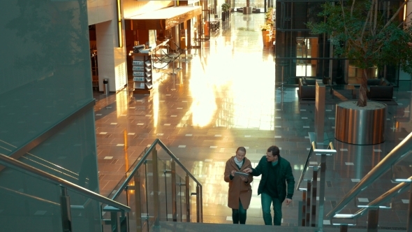 Young Couple With Pad Going Upstairs In Modern alt