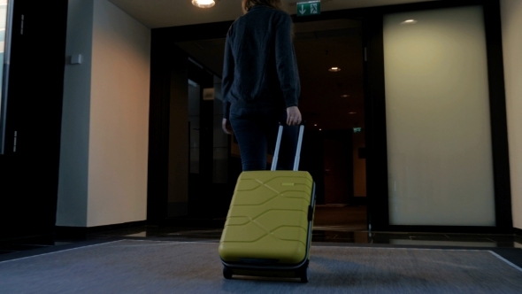 Woman With Travel Bag Walking To Her Hotel Room