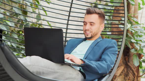 Young successful caucasian businessman works outdoor