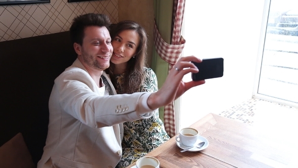 Photo Of Couple Taking Selfie At Cafe