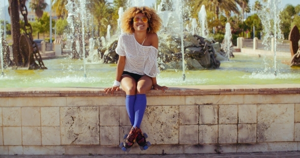 Happy Sexy Girl Sitting On Fountains Wall