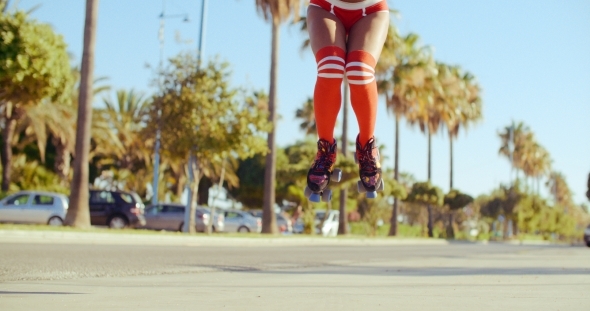 Girl In Skimpy Shorts Jumping On Roller Skates