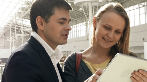 Young Happy Man And Woman Talking On Business With