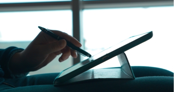 Woman Using Pen To Work With Touch Pad