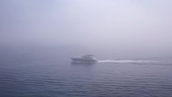 Speeding luxury boat into mysterious foggy ocean