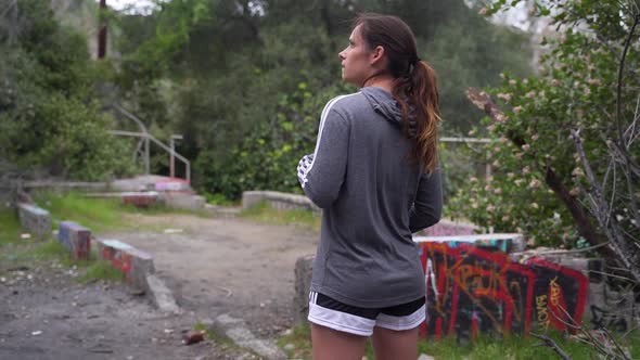 Girl looking away into the distance, passing soccer ball in hands, slow motion