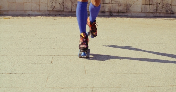 Close Up On Girls Feet While Riding Roller Skates