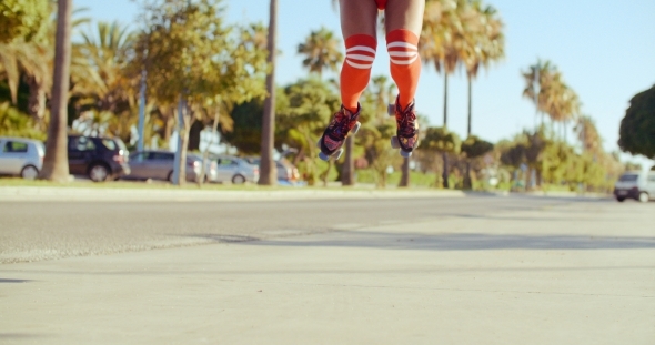 Girl In Skimpy Shorts Jumping On Roller Skates