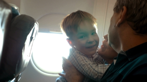 Boy And His Grandmother Hugging In The Plane