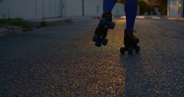 Young Woman Riding On Roller Skates