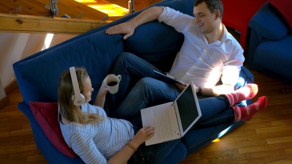 Young People Relaxing With Music At Home