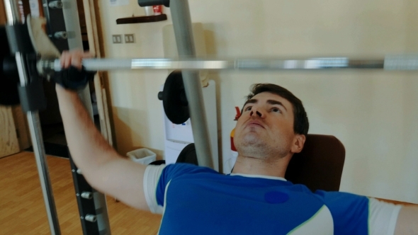 Man Working Out Hard On Chest Press Exercise alt